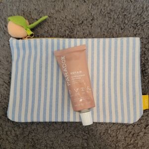 Ipsy striped bag with Paradox Repair Game changer hair mask